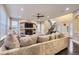 Comfortable living room featuring an open layout, large sectional, fireplace, and hardwood floors at 6401 S Millbrook Way, Aurora, CO 80016