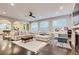 Open-concept living room with hardwood floors, recessed lighting, large sectional couch, and modern ceiling fan at 6401 S Millbrook Way, Aurora, CO 80016