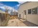 The exterior of the home features a small backyard, door, and partial fence at 2735 S Uravan St, Aurora, CO 80013