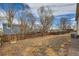 Spacious backyard with a wooden fence, some foliage, and potential for landscaping at 2735 S Uravan St, Aurora, CO 80013