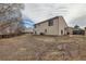 Large backyard features a home's siding, with a wooden fence at 2735 S Uravan St, Aurora, CO 80013