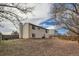 A spacious backyard with a home's siding, partially fenced, with scattered foliage at 2735 S Uravan St, Aurora, CO 80013