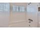 All-white tiled shower with bench and window for natural light at 2735 S Uravan St, Aurora, CO 80013