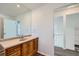 Bathroom vanity featuring a wood cabinet and a large mirror at 2735 S Uravan St, Aurora, CO 80013