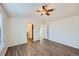Bedroom with wood-look floors, bright natural light, closet, and doorways at 2735 S Uravan St, Aurora, CO 80013