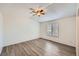 Bright bedroom featuring a neutral color scheme, wood-look floors, and a window at 2735 S Uravan St, Aurora, CO 80013