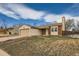 Exterior view of a single-Gathering home with a two-car garage and well-maintained lawn at 2735 S Uravan St, Aurora, CO 80013