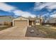 Charming one-story home featuring a brick chimney and attached two-car garage at 2735 S Uravan St, Aurora, CO 80013