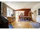Open dining area with hardwood floors, a vintage chandelier, and views of the kitchen and living spaces at 1339 Quince St, Denver, CO 80220