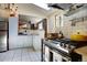 Bright and open kitchen with stainless appliances and hood with adjoining pass-through to living area at 1339 Quince St, Denver, CO 80220