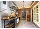 Quaint kitchen features brick accents, neutral tile floors, and an archway leading to another room at 1339 Quince St, Denver, CO 80220