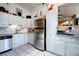 Traditional kitchen with white cabinetry, stainless steel appliances, and neutral tile flooring at 1339 Quince St, Denver, CO 80220