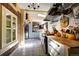 Bright kitchen features tile flooring, brick accents, stainless steel appliances, and seamless access to other rooms at 1339 Quince St, Denver, CO 80220