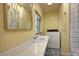 Bright laundry room with a vanity area with sink and mirror near a washing machine and dryer at 1339 Quince St, Denver, CO 80220