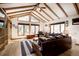 Bright living room featuring vaulted ceilings, wooden beams, and ample natural light at 1339 Quince St, Denver, CO 80220