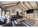 Comfortable living room with beamed ceilings, an area rug, a leather sofa and built-in shelving at 1339 Quince St, Denver, CO 80220