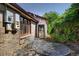 Charming outdoor patio featuring a brick wall and quaint metal table and chairs at 1339 Quince St, Denver, CO 80220