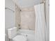 This stylish bathroom features tiled shower over tub combination, toilet and modern sink at 17505 E Mansfield Ave # 1412R, Aurora, CO 80013