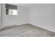 An empty bedroom featuring sleek, modern flooring with a window bringing in natural light at 17505 E Mansfield Ave # 1412R, Aurora, CO 80013