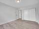 A clean bedroom with modern flooring, spacious closet and an open doorway to another room at 17505 E Mansfield Ave # 1412R, Aurora, CO 80013