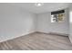 A well-lit bedroom features a window offering views of the outdoors and sleek, modern flooring at 17505 E Mansfield Ave # 1412R, Aurora, CO 80013