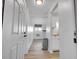 Bright entryway showing the main living area with wood-look floors and access to the kitchen at 17505 E Mansfield Ave # 1412R, Aurora, CO 80013