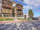 Condo building exterior view with multiple units and balconies, set against a blue sky at 17505 E Mansfield Ave # 1412R, Aurora, CO 80013