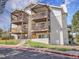 Exterior elevation showcasing a condo building with multiple units and outdoor wooden balconies at 17505 E Mansfield Ave # 1412R, Aurora, CO 80013