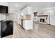 Bright kitchen with white cabinets, butcher block counters, stainless steel appliances, and modern backsplash at 17505 E Mansfield Ave # 1412R, Aurora, CO 80013