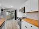 Bright kitchen with stainless steel appliances, butcher block countertops and sliding glass door to outdoor patio at 17505 E Mansfield Ave # 1412R, Aurora, CO 80013