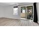 Light-filled living room featuring modern flooring and a sliding door to a patio with outdoor views at 17505 E Mansfield Ave # 1412R, Aurora, CO 80013