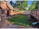 The backyard showcases a perfectly manicured lawn, stone borders, and mature trees enhancing the landscape and privacy at 911 Lincoln Pl, Boulder, CO 80302