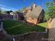 Spacious backyard with a well-maintained lawn and brick-lined garden beds surrounding a two-story brick home at 911 Lincoln Pl, Boulder, CO 80302