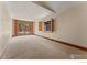 Finished basement with carpet, sliding glass door to outside, and a window at 911 Lincoln Pl, Boulder, CO 80302