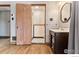 Bathroom with hardwood floors, a pedestal sink, and a black and white tiled shower at 911 Lincoln Pl, Boulder, CO 80302