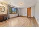 Bedroom featuring hardwood floors, a window with curtains, and a wooden door with a vintage mirror at 911 Lincoln Pl, Boulder, CO 80302