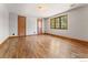 Spacious bedroom featuring hardwood floors, natural light, a ceiling light, and a window overlooking trees at 911 Lincoln Pl, Boulder, CO 80302