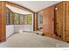 Bright bonus room with a wall of windows, wood paneling, and carpet at 911 Lincoln Pl, Boulder, CO 80302