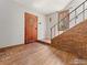 Foyer with brick accent wall, wooden floors, and a leaded glass window at 911 Lincoln Pl, Boulder, CO 80302