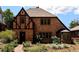 Charming Tudor home with brick facade, leaded glass window, and well-maintained landscaping at 911 Lincoln Pl, Boulder, CO 80302
