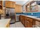 Kitchen with stainless steel appliances, light wood cabinets, and blue tiled backsplash at 911 Lincoln Pl, Boulder, CO 80302