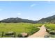 Scenic landscape view of the mountains with a walking path, surrounded by green grass and scattered trees at 911 Lincoln Pl, Boulder, CO 80302