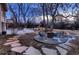 Cozy backyard with a firepit, stone pathways, and outdoor seating area at 6483 S Prince St, Littleton, CO 80120