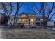 Large backyard with mature trees, a patio, and ample space for outdoor living at 6483 S Prince St, Littleton, CO 80120