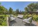 Relaxing backyard space featuring stylish outdoor furniture and lush green landscaping at 6483 S Prince St, Littleton, CO 80120