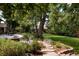 Backyard patio with comfortable seating, a fire pit, and beautiful landscaping at 6483 S Prince St, Littleton, CO 80120