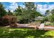 Serene backyard featuring a hammock, gazebo, garden beds, and lush landscaping at 6483 S Prince St, Littleton, CO 80120
