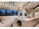 Elegant bathroom featuring a makeup vanity, soaking tub, and stylish floral wallpaper at 6483 S Prince St, Littleton, CO 80120