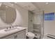 Updated bathroom featuring stylish finishes, a glass shower, and modern fixtures at 6483 S Prince St, Littleton, CO 80120