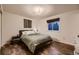 Cozy bedroom with a comfortable bed, dark wood floors, and natural light at 6483 S Prince St, Littleton, CO 80120